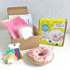 an assortment of craft items including a donut and pincuss in a box