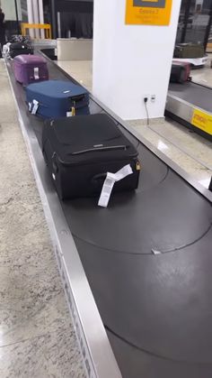 luggage sitting on top of an airport conveyor belt