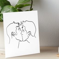 a black and white drawing of two people kissing on the forehead art board print by person