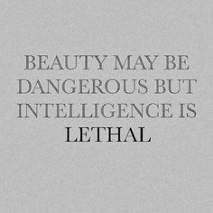 the words beauty may be dangerous but intelilince is lethal on a gray background