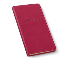 a red leather book with the word's name on it