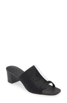 A half-translucent vamp strap amplifies the modern allure of a slide sandal balanced by a square toe and wrapped block heel. 2 3/4" heel (size 8.5) Cushioned footbed Leather and synthetic upper/leather lining/rubber sole Imported Elegant Mules With Stacked Heel And Single Toe Strap, Modern Stacked Heel Mules For Evening, Modern Black Formal Sandals, Modern Black Mules With Stacked Heel, Modern Black Mules For Summer, Modern Black Summer Mules, Modern Black Sandals With Medium Width, Black Mules With Sculpted Heel For Summer, Modern Black Mules With Deep Heel Cup