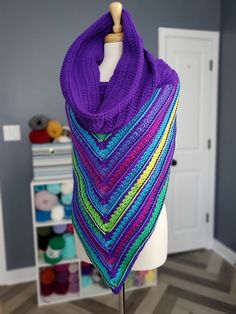 a purple shawl on a mannequin in a room