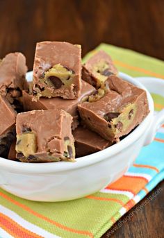 a white bowl filled with chocolate fudges on top of a colorful table cloth