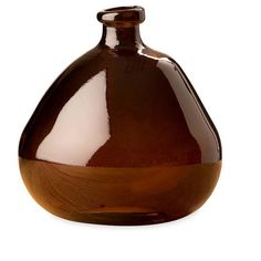 a brown vase sitting on top of a white table