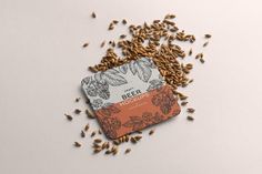 seeds are scattered on top of a card that says beer moguls with an orange border