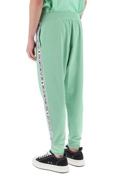 Dsquared2 track pants crafted in cotton and recycled polyester blend jersey. They feature elasticated waistband, side seam pockets, hem with elasticated cuffs and they're characterized by contrasting side bands with logo. Decorated with logo label on the fly. Relaxed fit. The model is 187 cm tall and wears size L. Size Info STANDARD Color Detail Green Made In Italy Material 55% PL 45% CO Season One spring Season Two summer Product clothing Brand Dsquared2 Size And Fit Logo Waistband Athleisure Sweatpants, Athleisure Sweatpants With Logo Waistband, Sporty Joggers With Logo Waistband For Streetwear, Sporty Green Pants With Elastic Side Panels, Green Athleisure Bottoms With Side Stripes, Green Sweatpants With Side Stripes For Streetwear, Green Athleisure Pants With Elastic Side Panels, Sporty Sweatpants With Logo Waistband, Sporty Sweatpants With Logo Waistband For Sports