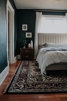 a bedroom with a bed and rug in it