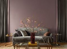 a living room with purple walls and furniture