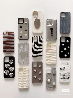 there are many different cell phones lined up on the white surface, each with an animal print design