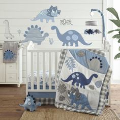 a baby's room with dinosaur decals on the wall and crib bedding