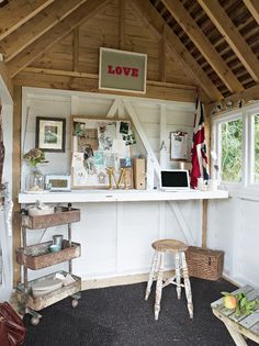 the inside of a small room with lots of clutter and decor on it's walls