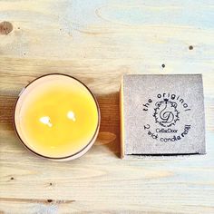 a candle sitting next to a box on a wooden table