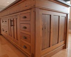 a kitchen island made out of wood with drawers