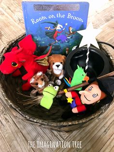 the room on the broom is filled with stuffed animals, books and other toys in a basket