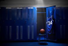 a basketball jersey hanging on a locker door next to a stool with a basketball in it