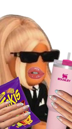 a barbie doll holding a pink drink and some candy with her tongue sticking out next to it