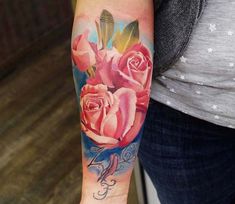 a woman with a rose tattoo on her arm