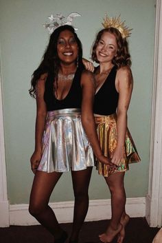 two women standing next to each other in front of a door wearing disco outfits and headbands