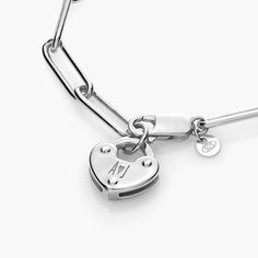 Size Guide  Safety PolicyCare InstructionsLink what you love in our Heart Charm Lock Bracelet. Fashioned from premium silver, it also features an engravable charm that you can customize to your heart's content.925 Sterling Silver: Timeless and durable, sterling silver is always a classic choice. As pure silver is too soft to last, 925 silver combines 92.5% pure silver and 7.5% copper.Customize Me! Personalize your heart charm with up to 3 engravings.How To Make It Yours: Let your name shine by e Adjustable Heart-shaped Sterling Silver Bracelet, Heart-shaped Sterling Silver Bracelets With Clasp, Silver Heart-shaped Stainless Steel Charm Bracelet, Silver Heart-shaped Bracelet With Toggle Clasp, Silver Heart-shaped Lock Jewelry, Lock Bracelet, Heart Jewelry, Pure Silver, Silver Bracelets