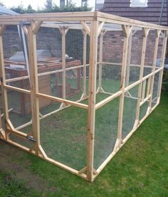 an outdoor chicken coop made out of wood and wire