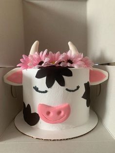 a cake decorated to look like a cow with horns and flowers on it's head