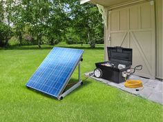 a small solar panel sitting in the grass next to a tool box and an air conditioner