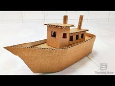 a cardboard boat that is sitting on the floor