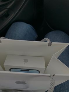 the inside of an apple box with two iphones in it's bottom compartment