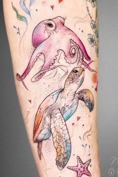 a woman's leg with an octopus and sea turtle tattoo on the side of her arm