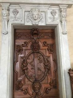 an ornate wooden door with carvings on it