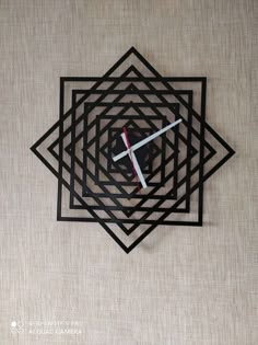 a clock that is on the side of a wall with a knife in it's center