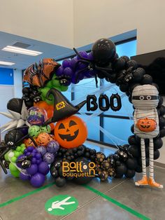 an entrance decorated for halloween with balloons and decorations