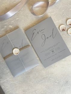 the wedding stationery is laid out on the table with ribbon and ribbons around it