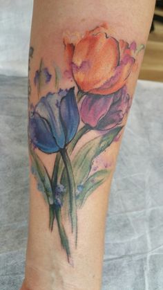 a woman's leg with flowers painted on it