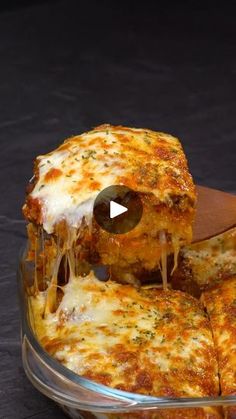 the pizza is being cut into pieces with cheese and sauce on it's surface