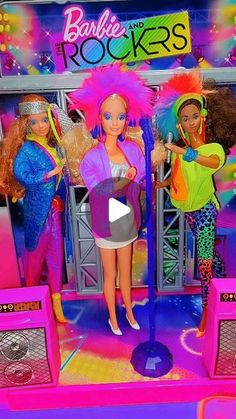 barbie dolls are standing on stage with microphones in front of them and the words barbie rocks