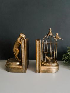 two golden figurines are sitting next to each other