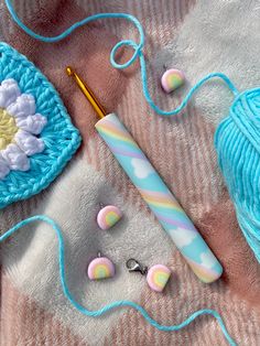 crochet and knitting supplies laid out on a blanket