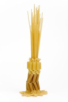 a bunch of pasta sticks sitting on top of each other in front of a white background