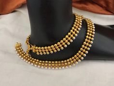 Anklets Gold Finish / Gold Beaded With Studded Pearls/ 2 Anklets /of inch Wide  Long 10 inches /Extra Chain links will added This item is perfect for any occasion, from party wear to casual wear! It is traditional and trendy at the same time. DETAILS: Includes two anklets. Length: 10  in. Weight: 2.45oz (70  g) Material: Imitation gold. Beads with Pearls . Finish: Premium gold finish.  NOTE: We try our best to show you photos of our items as they appear in real life, but please note that variations in color occur due to differences in lighting and screen settings.  PRODUCT CARE: - Avoid contact with heat/fire, water, and chemicals such as perfumes or any sprays to prevent product damage.  - Store wrapped in butter paper, cotton cloth, or the provided box. Anklets Gold, Butter Paper, Star Anklet, Fire Water, Real Jewelry, Elegant Sets, Chain Links, German Silver, Bangle Set