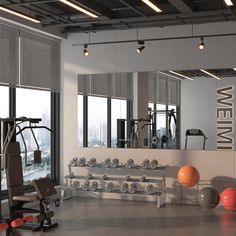 an empty gym with exercise equipment in the foreground and large windows to the right