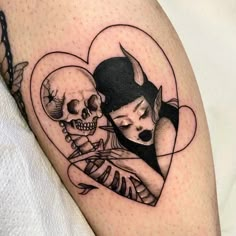 a woman and skeleton tattoo on the thigh