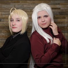 two women with white hair are posing for the camera