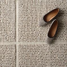 two pairs of shoes sitting on top of a rug