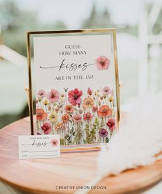 a sign that says guess how many flowers are in the air on top of a table