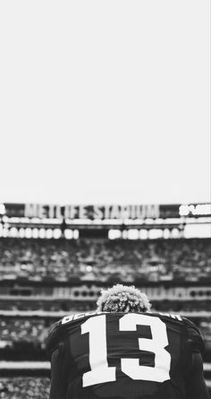 a football player standing in front of an empty stadium