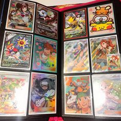 an open book with various pokemon cards on the front and back pages, all in different designs