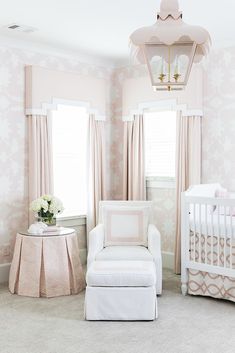 a baby's room with pink and white decor