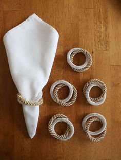 there are four napkin rings on the table